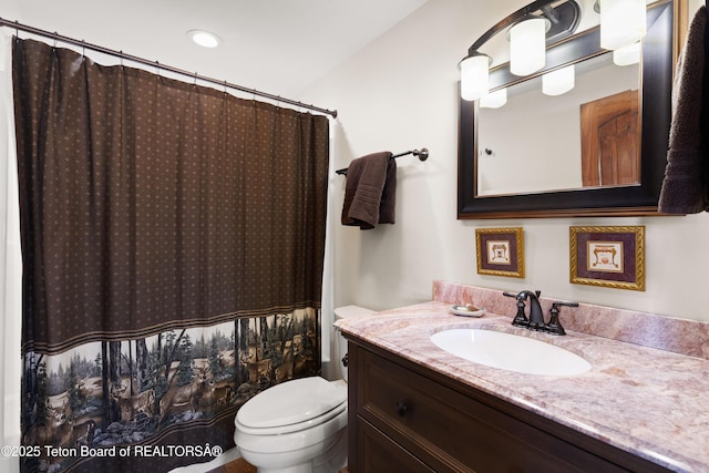 bathroom with a shower with curtain, vanity, and toilet