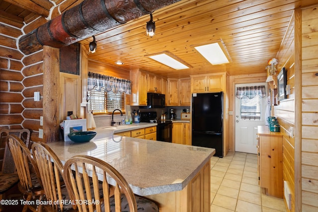 kitchen featuring sink, a wealth of natural light, black appliances, and kitchen peninsula