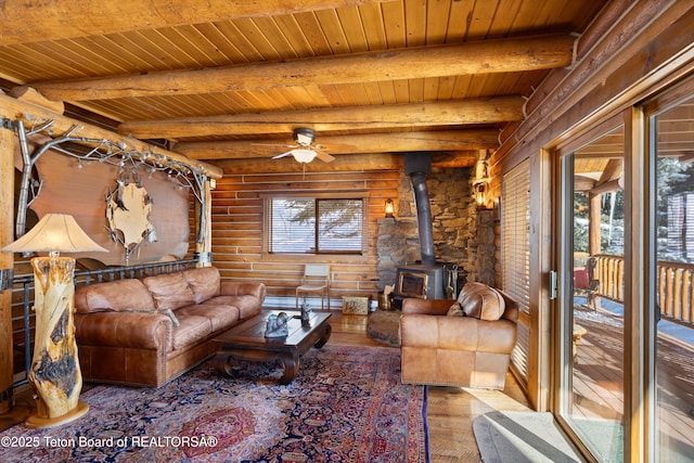 living room with beamed ceiling, a wood stove, wooden ceiling, and light hardwood / wood-style flooring