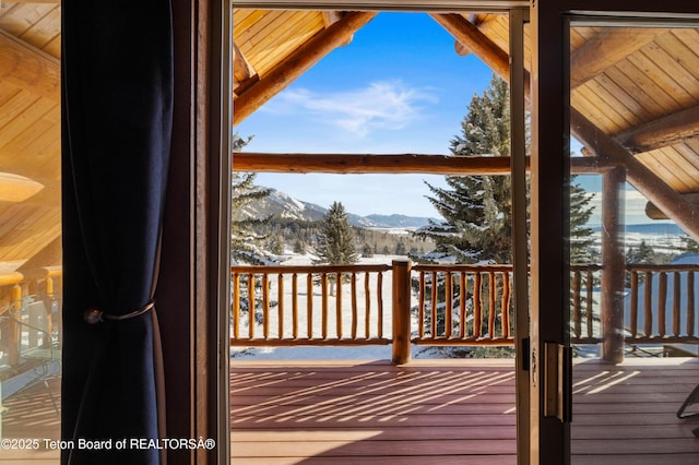 snow covered deck featuring a mountain view