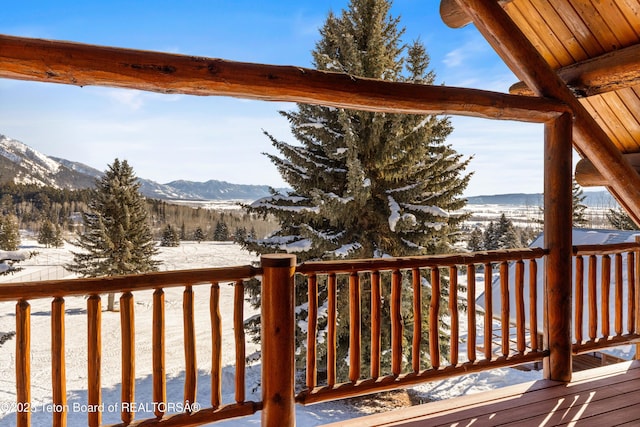 snow covered deck featuring a mountain view