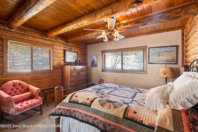 carpeted bedroom with beam ceiling, wooden ceiling, and ceiling fan