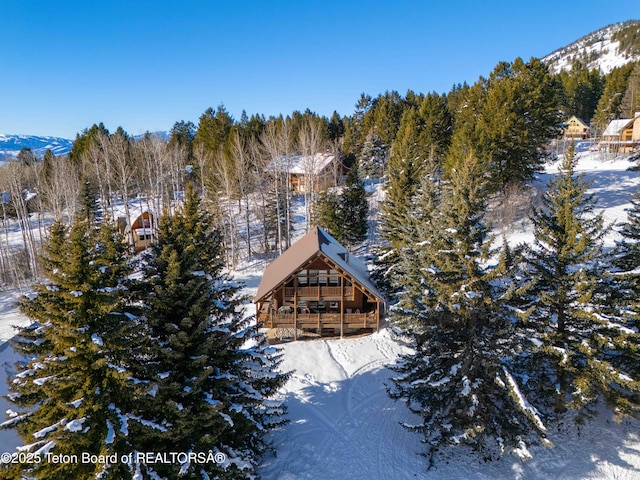 snowy aerial view with a mountain view