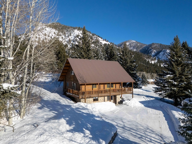 view of front of house featuring a deck with mountain view