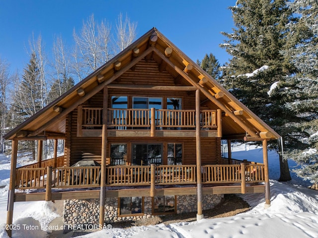 view of front of home with a wooden deck and french doors