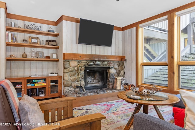 living room featuring hardwood / wood-style flooring and a stone fireplace