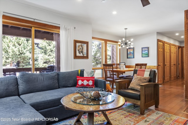 living room featuring an inviting chandelier and wood-type flooring