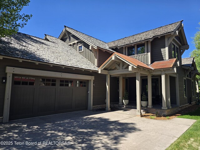 46 Scott Dr, Victor, ID 83455 - view of front of home featuring concrete driveway, an attached garage, and a porch