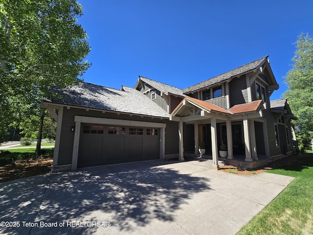 46 Scott Dr, Victor, ID 83455 - view of front of property with concrete driveway, an attached garage, and covered porch