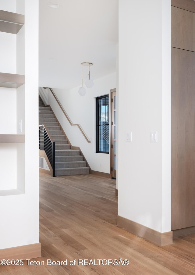 staircase with wood-type flooring