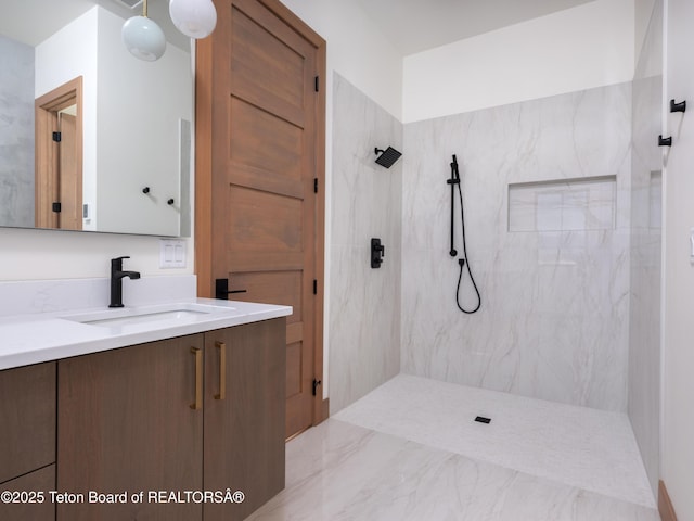 bathroom with vanity and a tile shower