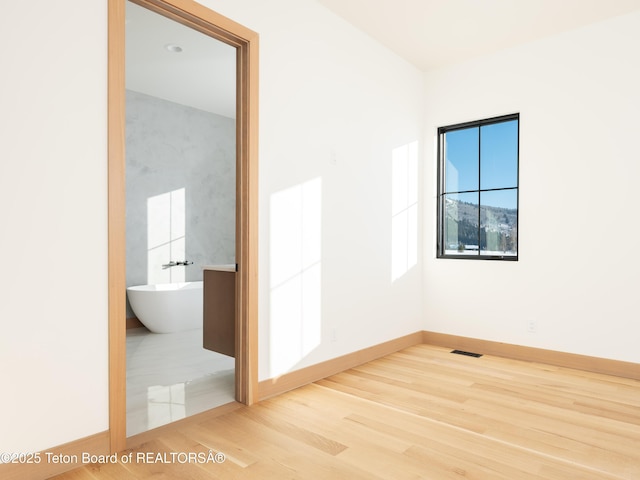 spare room with wood-type flooring