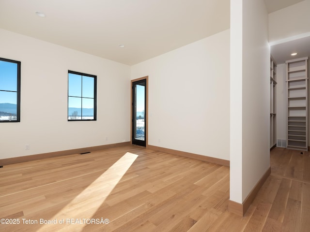 spare room featuring light hardwood / wood-style floors