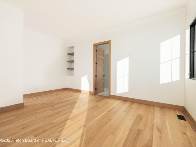 spare room with light hardwood / wood-style floors