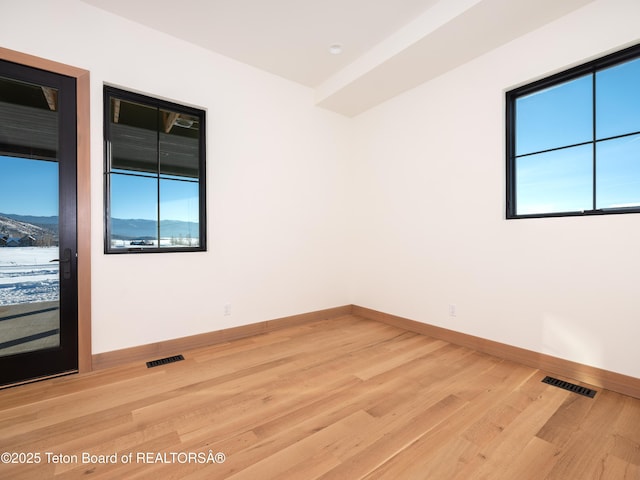 empty room with hardwood / wood-style floors