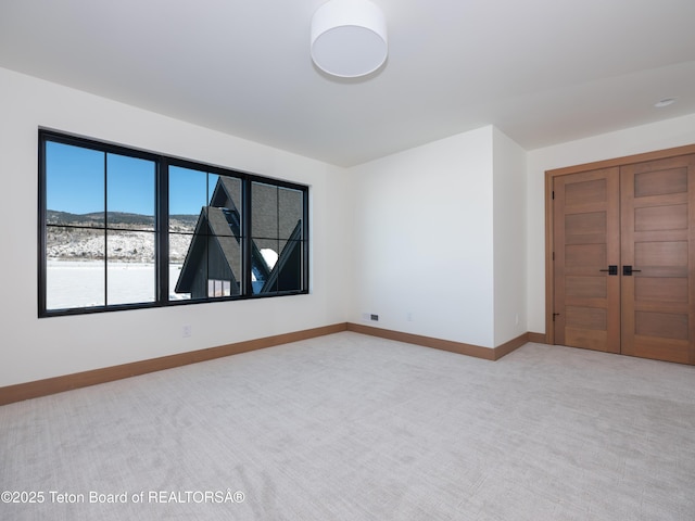 interior space with light carpet and a mountain view