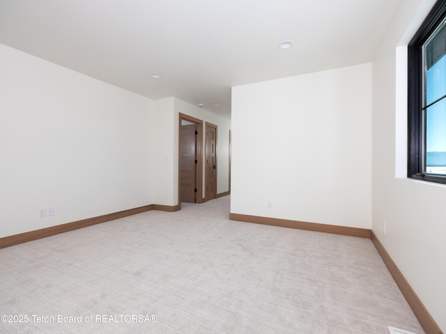 empty room featuring light carpet