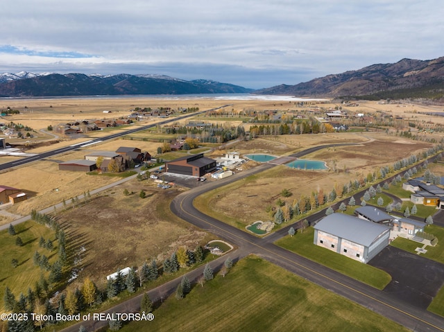 drone / aerial view featuring a mountain view and a rural view