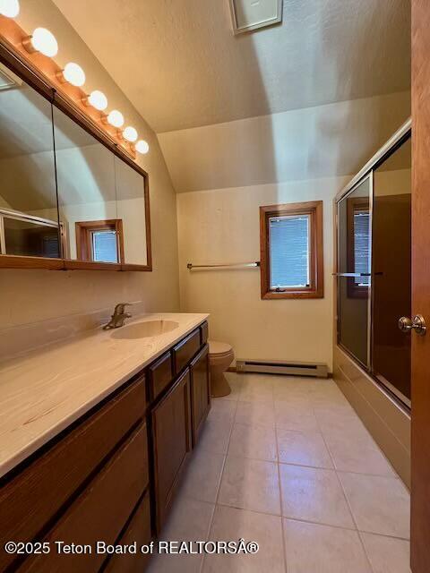 full bathroom with tile patterned floors, toilet, vaulted ceiling, enclosed tub / shower combo, and a baseboard heating unit