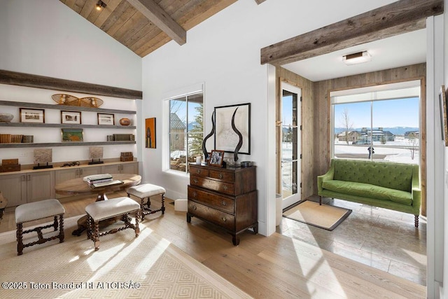 living area with lofted ceiling with beams, wooden ceiling, and light wood-type flooring