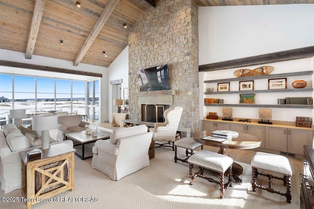 living room with wood ceiling, a fireplace, beam ceiling, and high vaulted ceiling