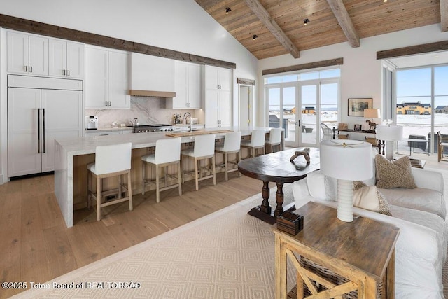 living room with wood ceiling, high vaulted ceiling, french doors, and a wealth of natural light