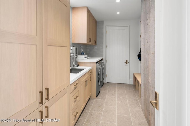 kitchen with washer and dryer and light brown cabinets