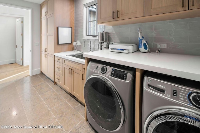 laundry area featuring separate washer and dryer and sink