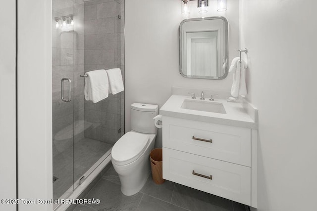 bathroom featuring vanity, tile patterned flooring, a shower with shower door, and toilet