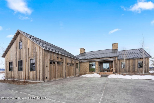 back of house featuring a garage