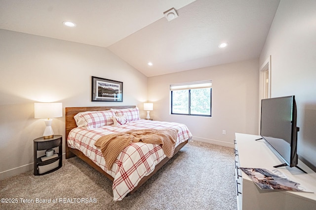 bedroom featuring lofted ceiling and carpet