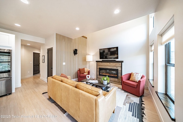 living room with a wealth of natural light and light hardwood / wood-style flooring