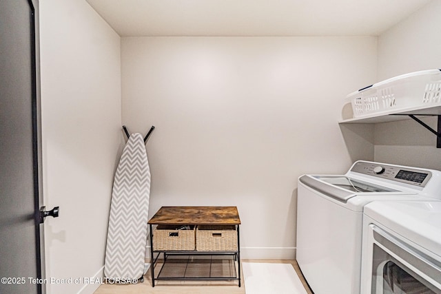 clothes washing area featuring light hardwood / wood-style floors and washing machine and clothes dryer