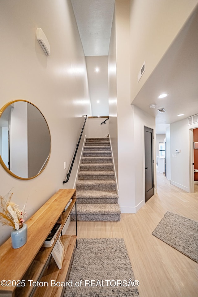 staircase featuring hardwood / wood-style flooring