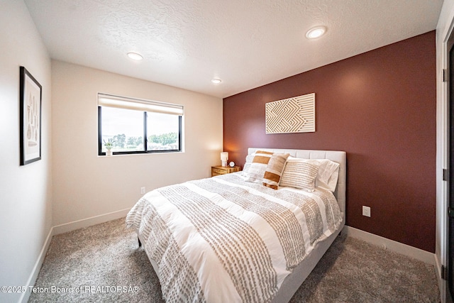 bedroom featuring a textured ceiling and carpet