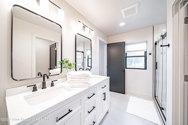 bathroom featuring vanity, tile patterned floors, and walk in shower