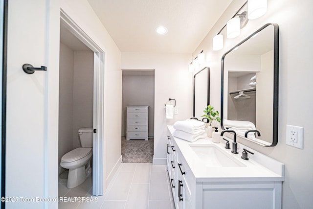 bathroom featuring vanity, tile patterned floors, and toilet