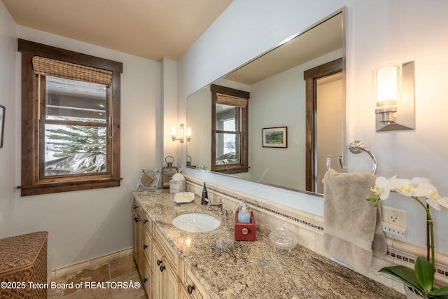 380 Cottongrass Rd, Driggs, ID 83422 - bathroom featuring vanity, baseboards, and stone finish floors