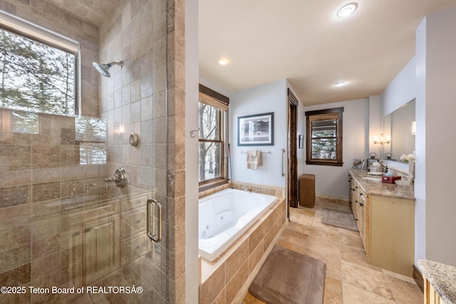 380 Cottongrass Rd, Driggs, ID 83422 - bathroom with a stall shower, vanity, a jetted tub, recessed lighting, and baseboards