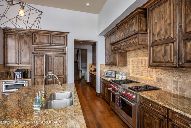 380 Cottongrass Rd, Driggs, ID 83422 - kitchen with a sink, premium appliances, tasteful backsplash, dark stone counters, and recessed lighting