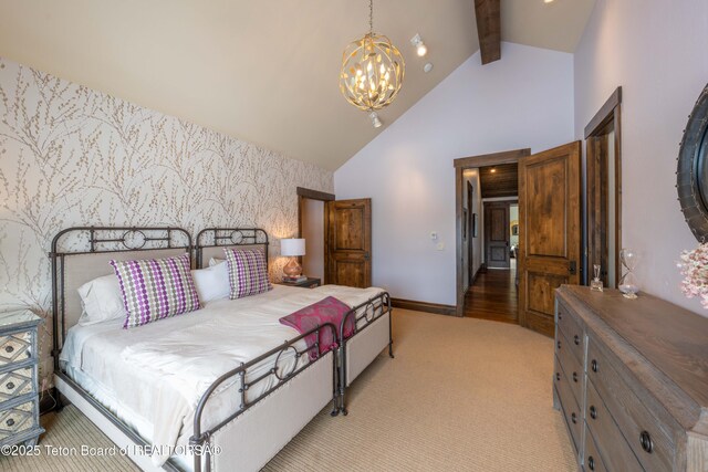 380 Cottongrass Rd, Driggs, ID 83422 - bedroom featuring wallpapered walls, an accent wall, a chandelier, baseboards, and high vaulted ceiling