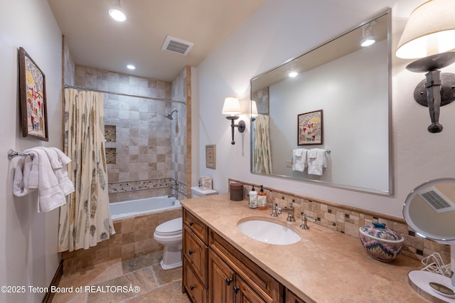 380 Cottongrass Rd, Driggs, ID 83422 - bathroom featuring vanity, tiled shower / bath, toilet, and recessed lighting