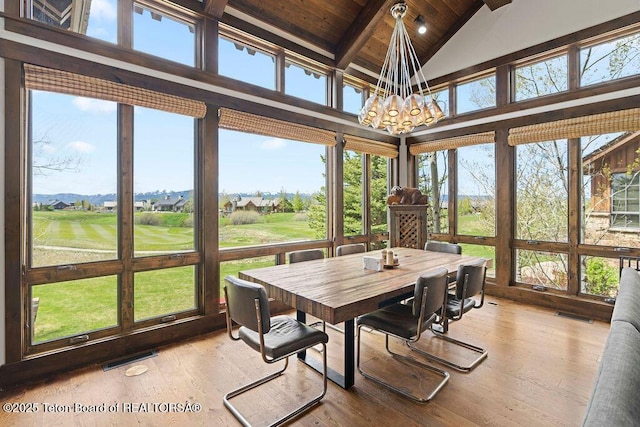 380 Cottongrass Rd, Driggs, ID 83422 - sunroom featuring wooden ceiling with exposed beams, a chandelier, hardwood / wood-style floors, golf course view, and high vaulted ceiling