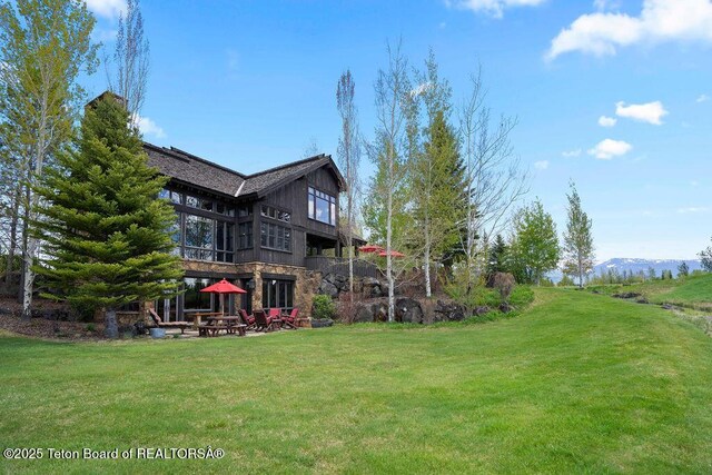 380 Cottongrass Rd, Driggs, ID 83422 - view of green lawn with a patio