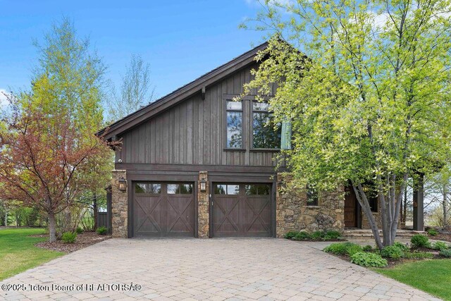 380 Cottongrass Rd, Driggs, ID 83422 - view of front of property with stone siding, decorative driveway, and a garage