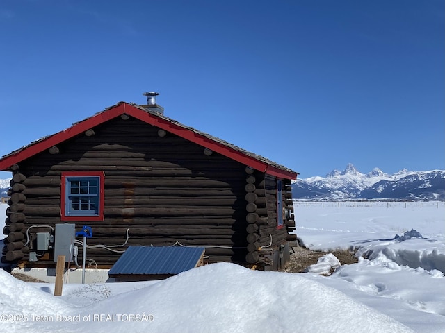 view of snowy exterior featuring a mountain view