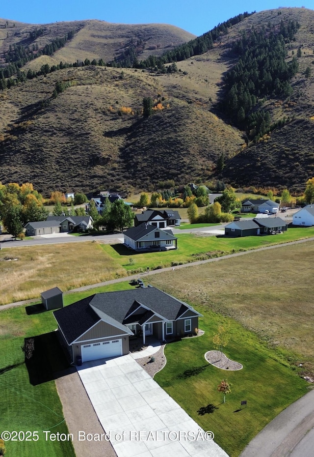 birds eye view of property featuring a mountain view