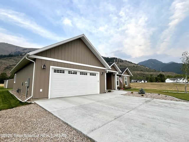 view of front of property featuring a mountain view, a garage, and a front yard