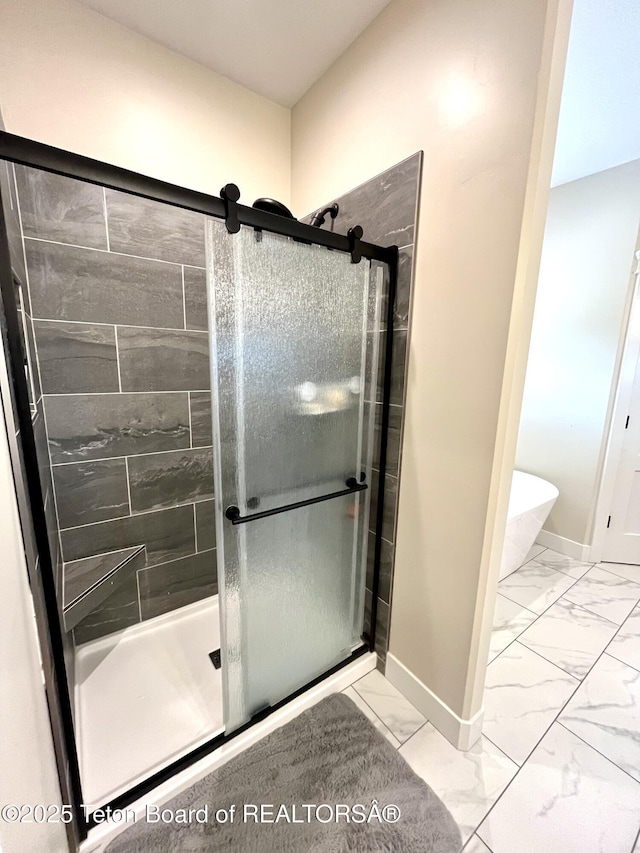 bathroom featuring a shower with door