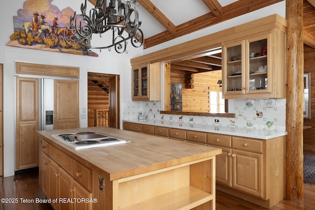 kitchen with glass insert cabinets, dark wood-type flooring, butcher block countertops, electric stovetop, and beamed ceiling